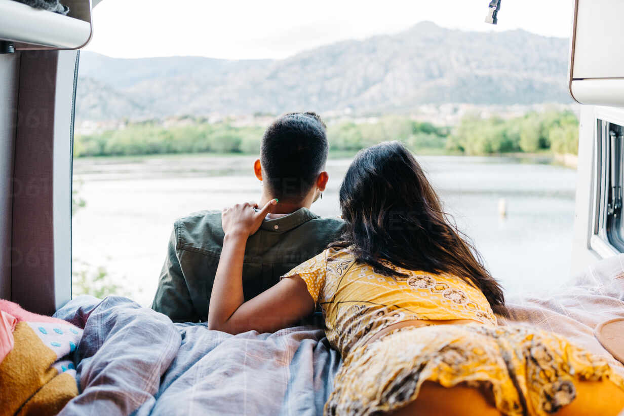 https://us.images.westend61.de/0001710274pw/back-view-of-unrecognizable-romantic-couple-enjoying-landscape-of-green-hills-and-river-while-resting-together-in-camper-van-during-summer-trip-in-nature-ADSF37723.jpg